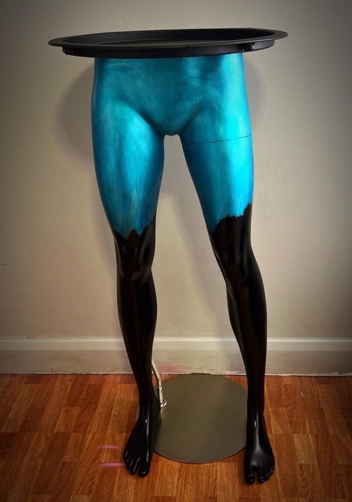 blue and black painted mannequin leg table